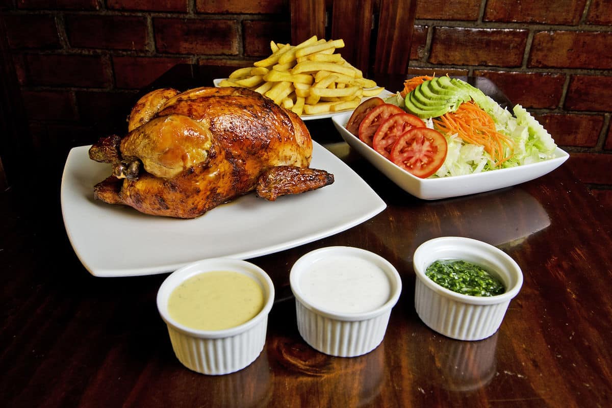 Pollo a la brasa with salad and dipping sauces